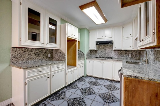 kitchen featuring light stone countertops, white cabinetry, sink, ventilation hood, and stainless steel gas stovetop