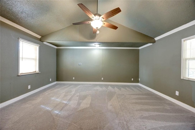 carpeted empty room with ceiling fan, a textured ceiling, lofted ceiling, and ornamental molding