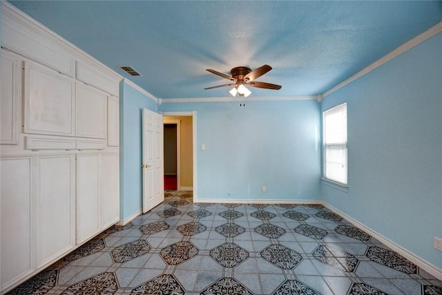 unfurnished bedroom with ceiling fan, a closet, and crown molding