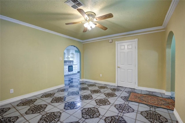 spare room featuring ceiling fan, crown molding, and a textured ceiling