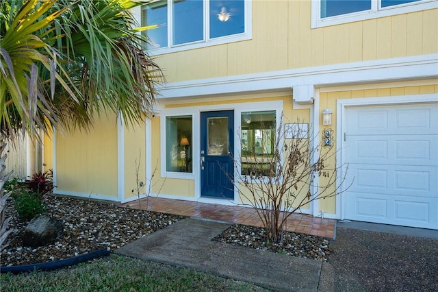 doorway to property with a garage