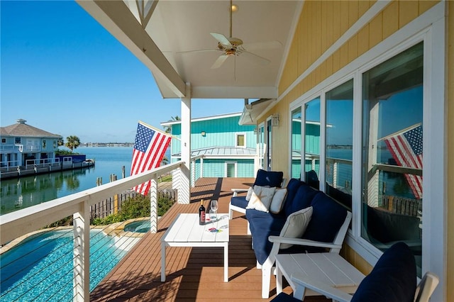 balcony featuring ceiling fan, outdoor lounge area, and a water view