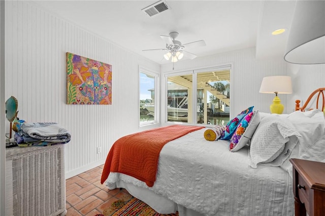 bedroom with brick floor, visible vents, ceiling fan, and baseboards