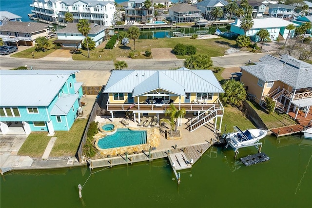 birds eye view of property with a residential view and a water view