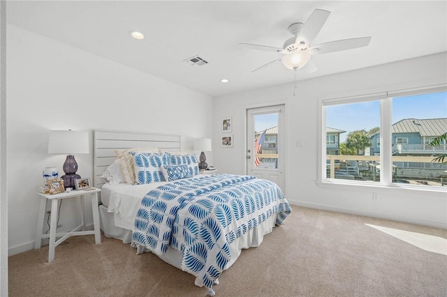 carpeted bedroom featuring access to exterior, recessed lighting, visible vents, and baseboards