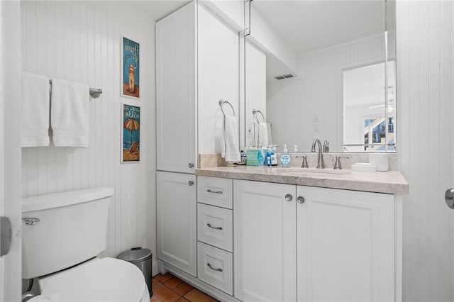 bathroom with tile patterned flooring, visible vents, vanity, and toilet