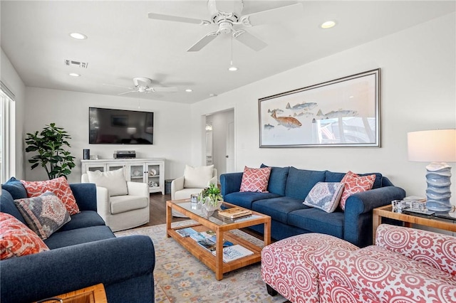 living room with recessed lighting, visible vents, ceiling fan, and light wood finished floors