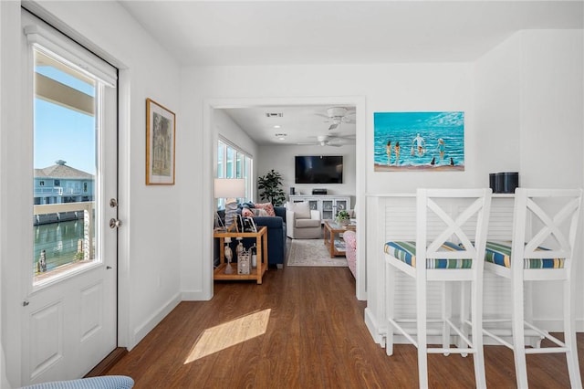 foyer featuring ceiling fan, visible vents, baseboards, and dark wood-style flooring