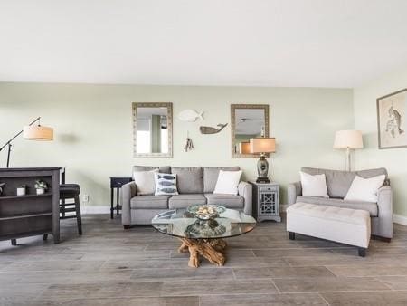 living area with wood finished floors and baseboards