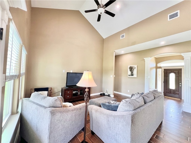 living room featuring decorative columns, dark hardwood / wood-style flooring, and plenty of natural light