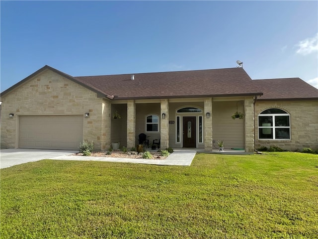 ranch-style home featuring a porch, a garage, and a front yard