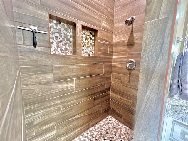 bathroom with a tile shower