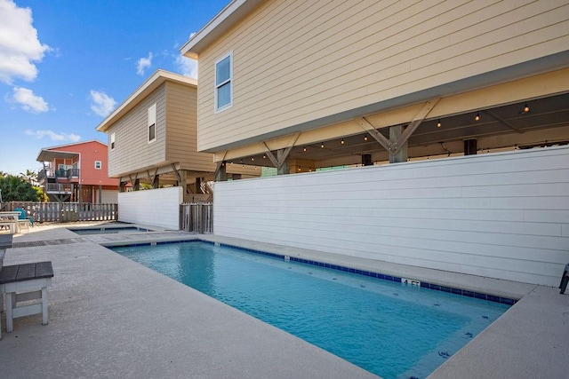 view of pool featuring a patio area, fence, and a fenced in pool