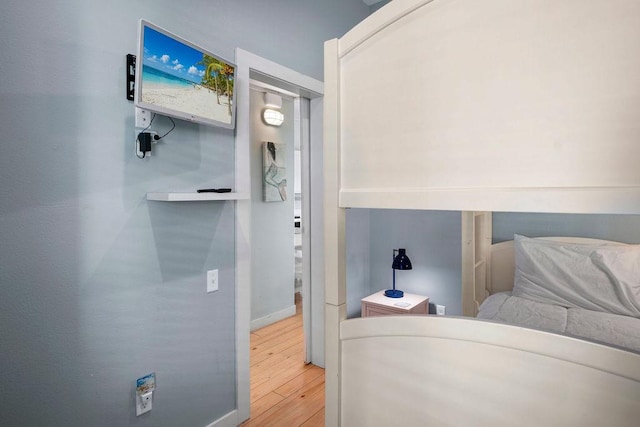 bedroom featuring wood finished floors and baseboards