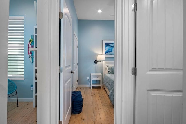 bathroom featuring baseboards, plenty of natural light, and hardwood / wood-style floors