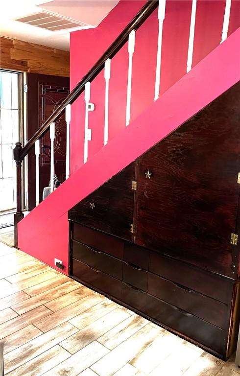 stairway with hardwood / wood-style floors