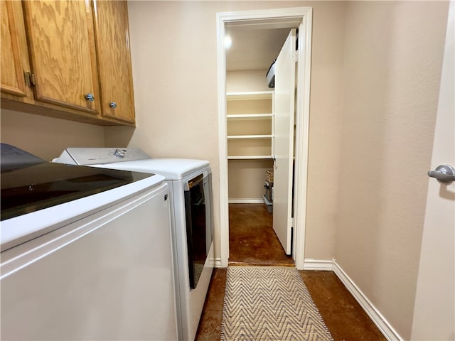 laundry area with cabinets and washer and clothes dryer