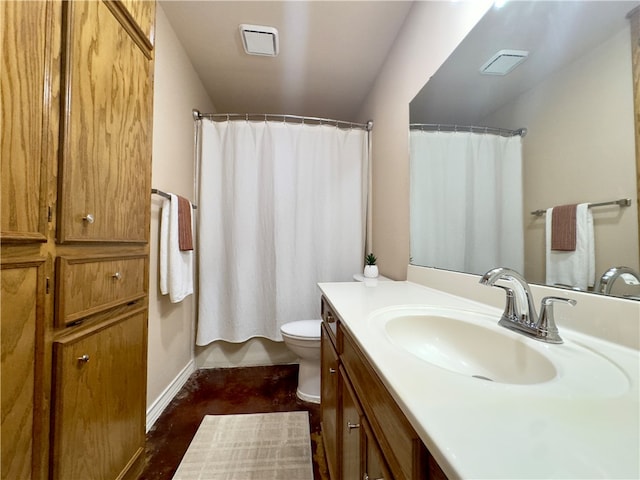 bathroom featuring vanity, toilet, and walk in shower