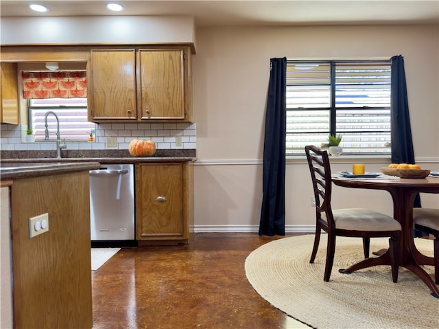 kitchen featuring decorative backsplash, stainless steel dishwasher, and sink