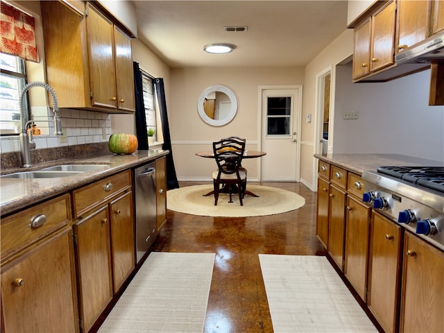 kitchen with sink, appliances with stainless steel finishes, and tasteful backsplash