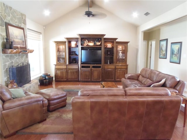 425 Seco Dr, Portland, TX 78374 - living area featuring a ceiling fan, a stone fireplace, and wood finished floors