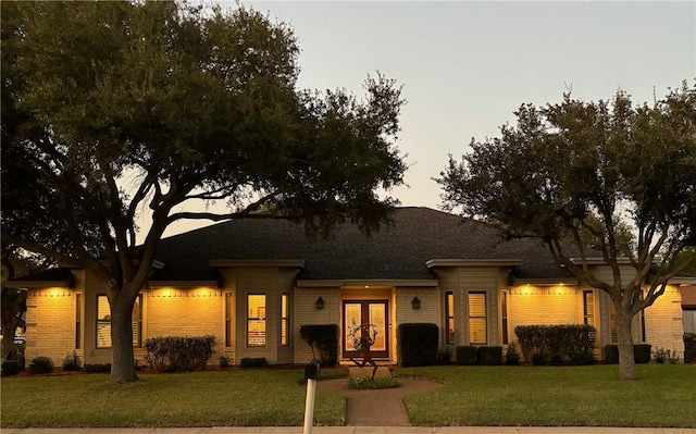 425 Seco Dr, Portland, TX 78374 - single story home featuring a front lawn, french doors, a shingled roof, and brick siding