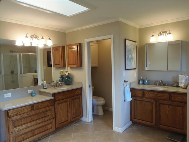 425 Seco Dr, Portland, TX 78374 - full bath with a shower stall, tile patterned flooring, two vanities, ornamental molding, and a skylight