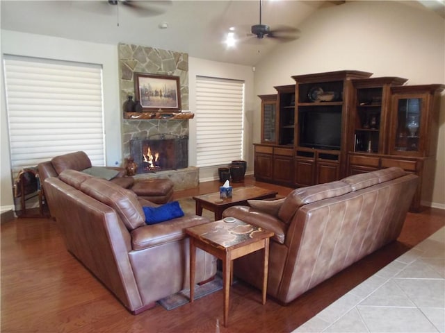 425 Seco Dr, Portland, TX 78374 - living room with ceiling fan, light wood-style floors, a stone fireplace, and lofted ceiling