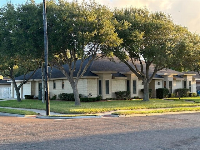 425 Seco Dr, Portland, TX 78374 - view of front of house with brick siding and a front lawn
