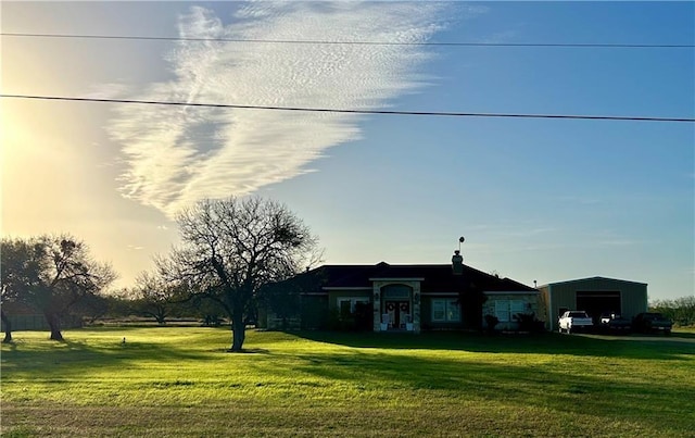 ranch-style home featuring an outbuilding, a yard, and a carport