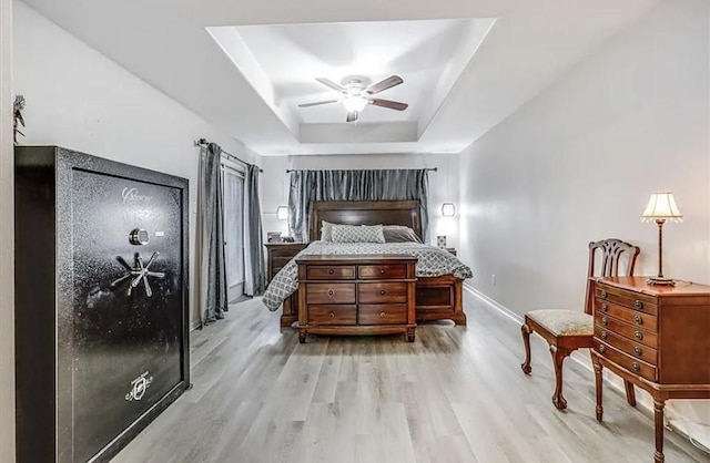 14877 Cobo De Bara, Corpus Christi, TX 78418 - bedroom featuring light wood finished floors, a tray ceiling, and ceiling fan