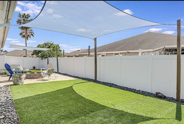 14877 Cobo De Bara, Corpus Christi, TX 78418 - fenced backyard with a fire pit and a patio
