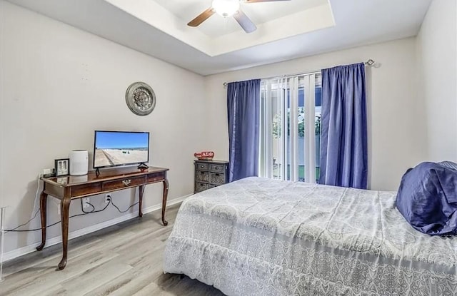 14877 Cobo De Bara, Corpus Christi, TX 78418 - bedroom with wood finished floors, a tray ceiling, multiple windows, and a ceiling fan