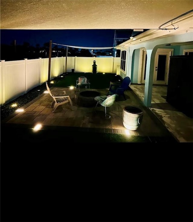 14877 Cobo De Bara, Corpus Christi, TX 78418 - patio at night featuring a fenced backyard and a patio