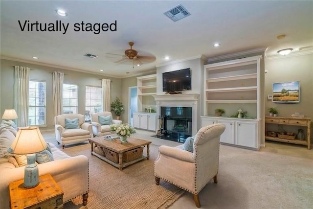 5617 Grand Lake Cir, Robstown, TX 78380 - living room with ornamental molding, ceiling fan, recessed lighting, a fireplace with flush hearth, and light carpet
