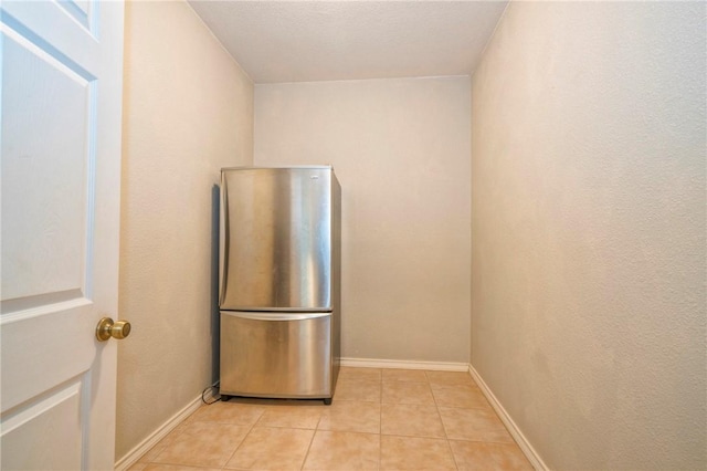 5617 Grand Lake Cir, Robstown, TX 78380 - kitchen featuring light tile patterned floors and freestanding refrigerator