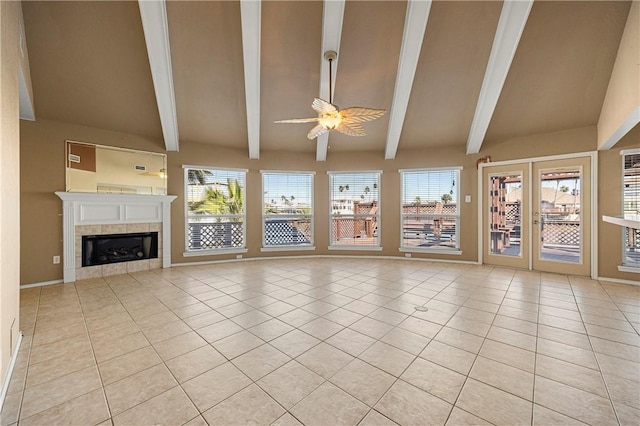 unfurnished living room with light tile patterned flooring, plenty of natural light, and lofted ceiling with beams