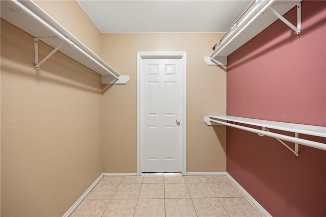 spacious closet featuring light tile patterned floors