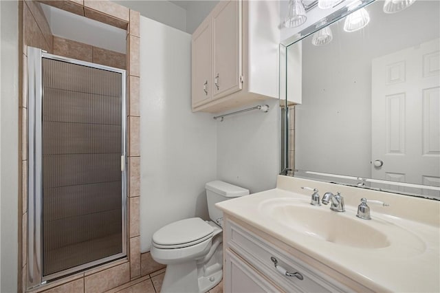 full bathroom with vanity, toilet, a stall shower, and tile patterned flooring