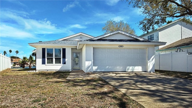 single story home with fence, a garage, driveway, and stucco siding