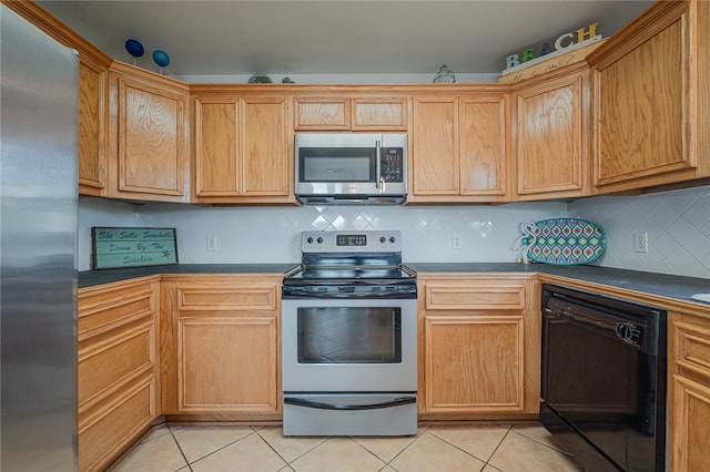 kitchen with stainless steel appliances, light tile patterned flooring, and tasteful backsplash