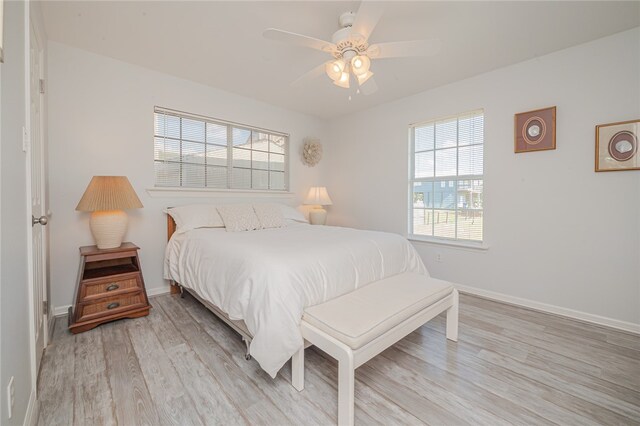 bedroom with light wood-type flooring and ceiling fan