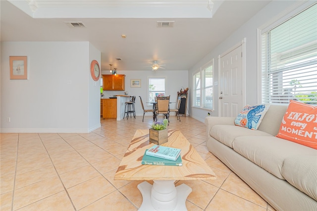 living room with ceiling fan and light tile patterned floors