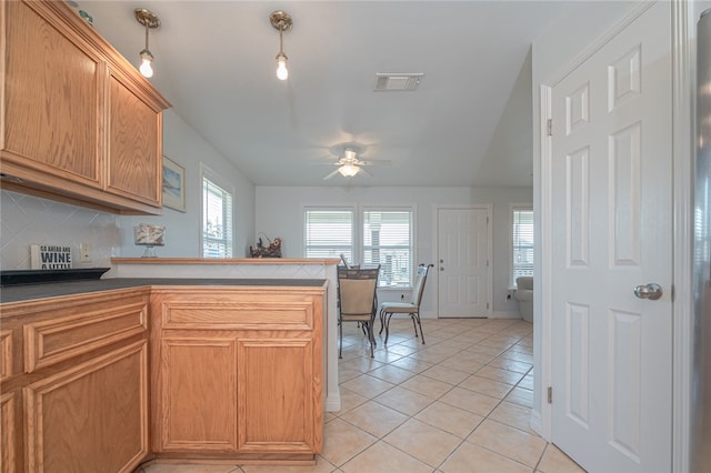 kitchen featuring decorative backsplash, ceiling fan, and light tile patterned flooring