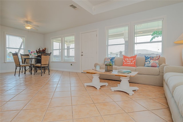 living room with ceiling fan, light tile patterned floors, and crown molding