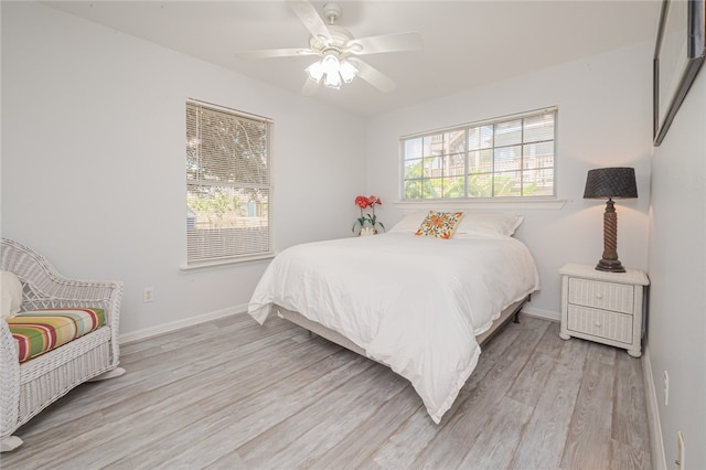 bedroom featuring light wood-type flooring and ceiling fan