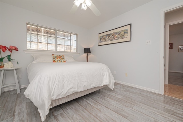 bedroom with ceiling fan and light hardwood / wood-style flooring