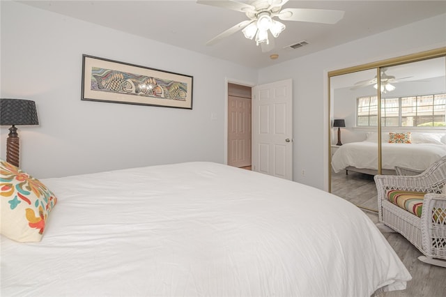 bedroom featuring a closet, wood-type flooring, and ceiling fan