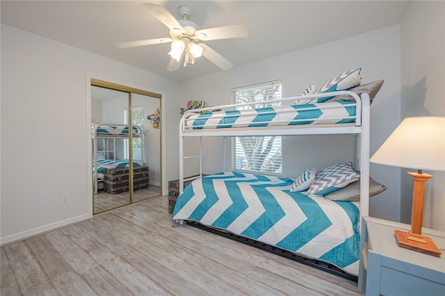 bedroom with hardwood / wood-style floors, ceiling fan, and a closet