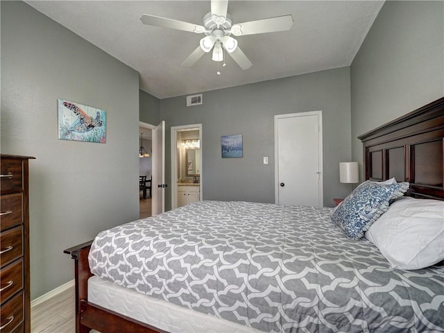 bedroom with light wood-style flooring, visible vents, and ceiling fan